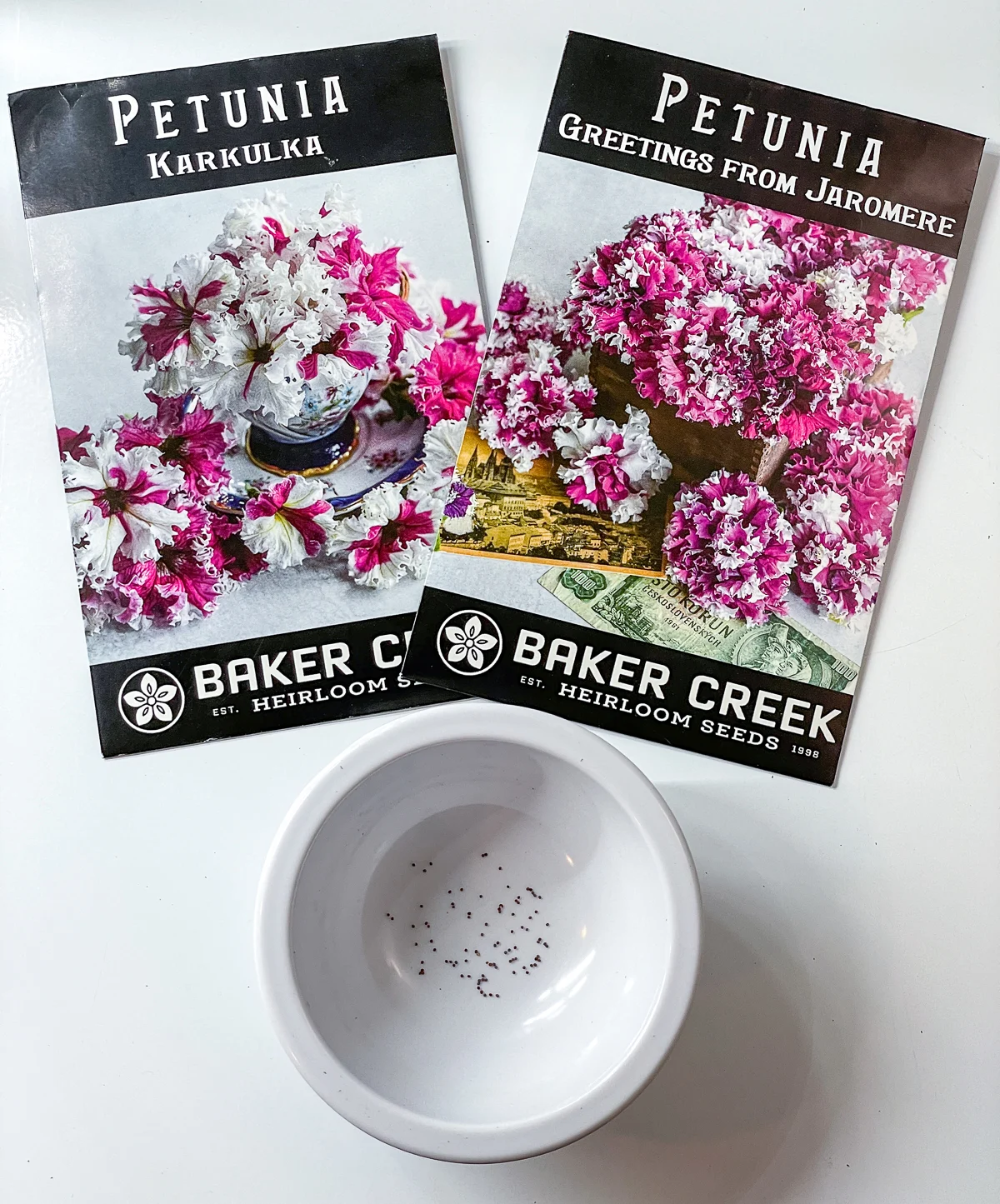 two petunia seed packets from Baker Creek with bowl of petunia seeds