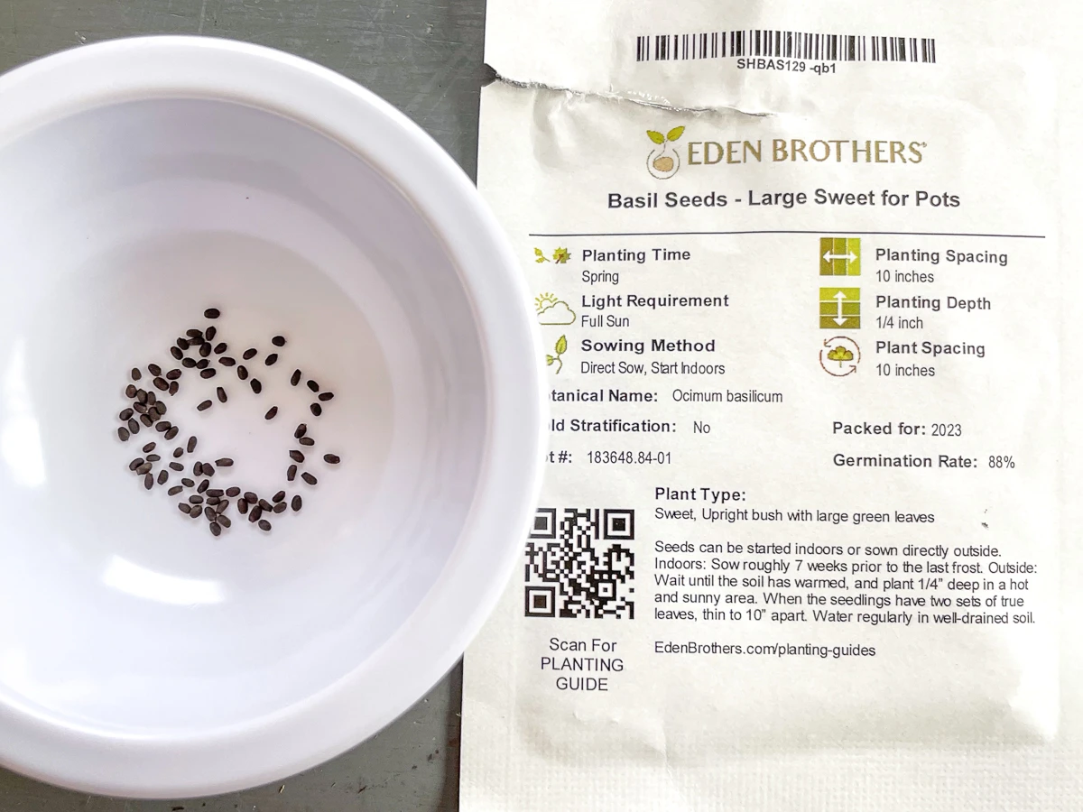 basil seeds in white bowl next to seed packet