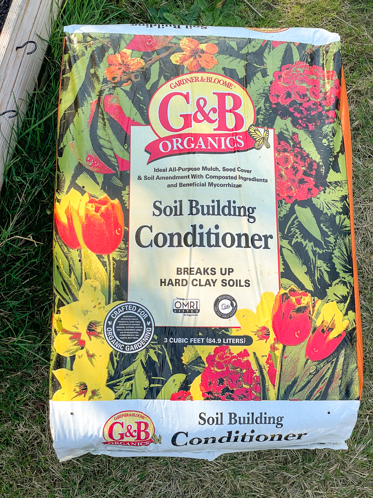 bag of G&B soil building conditioner next to raised bed